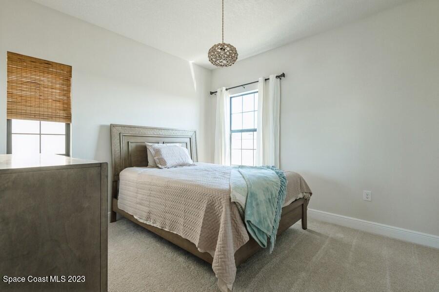 8072 Rungsted Lane Melbourne, FL 32940 - Photo 46 of 59 a bedroom with a bed and window