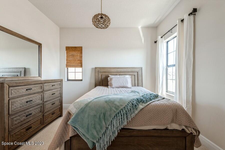 8072 Rungsted Lane Melbourne, FL 32940 - Photo 47 of 59 a bedroom with a bed and window