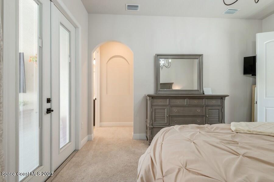 8072 Rungsted Lane Melbourne, FL 32940 - Photo 54 of 59 a bedroom with a bed and a dresser