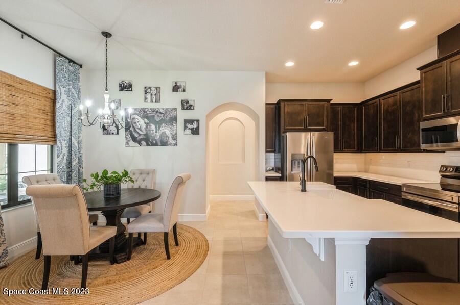 8072 Rungsted Lane Melbourne, FL 32940 - Photo 10 of 59 a dining room with furniture and window