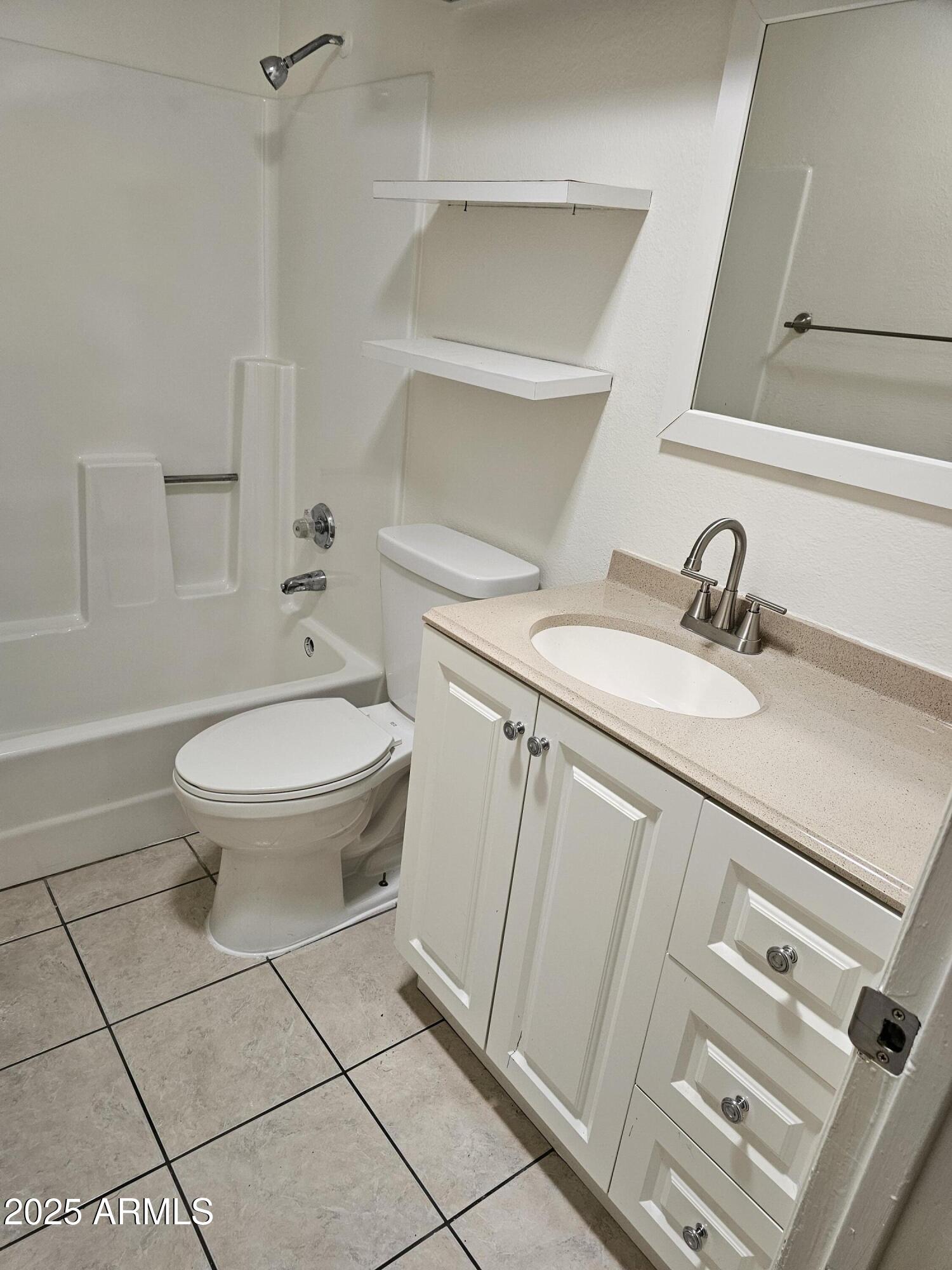 633 West Southern Avenue, Unit 1118 Tempe, AZ 85282 - Photo 6 of 12 a bathroom with a sink a toilet and a mirror