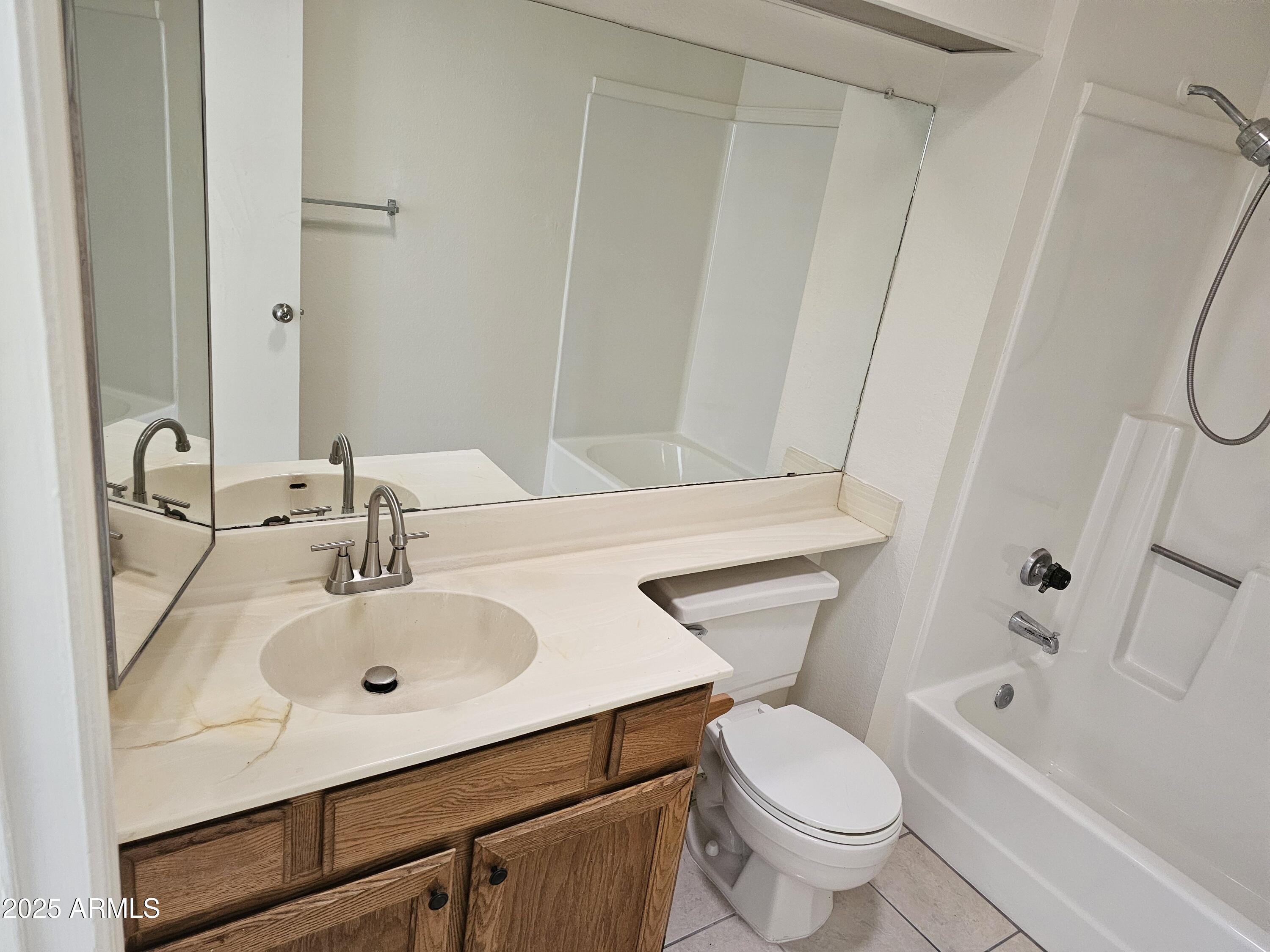 633 West Southern Avenue, Unit 1118 Tempe, AZ 85282 - Photo 8 of 12 a bathroom with a sink toilet and shower