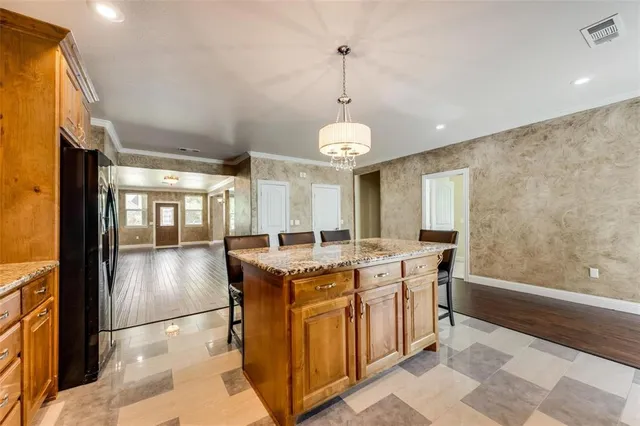 a kitchen with stainless steel appliances granite countertop a stove and a refrigerator