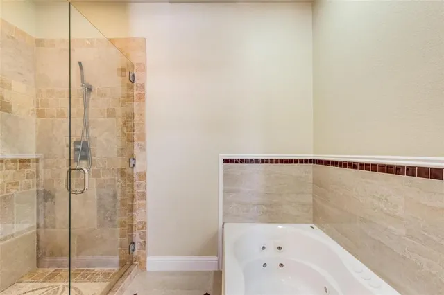 a bathroom with a shower and a glass door