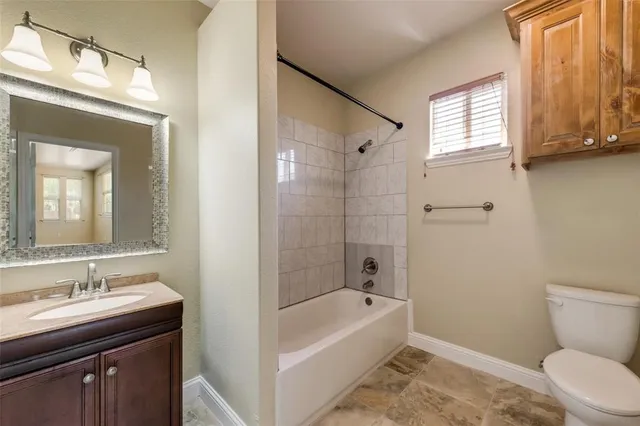 a bathroom with a sink a toilet and bathtub