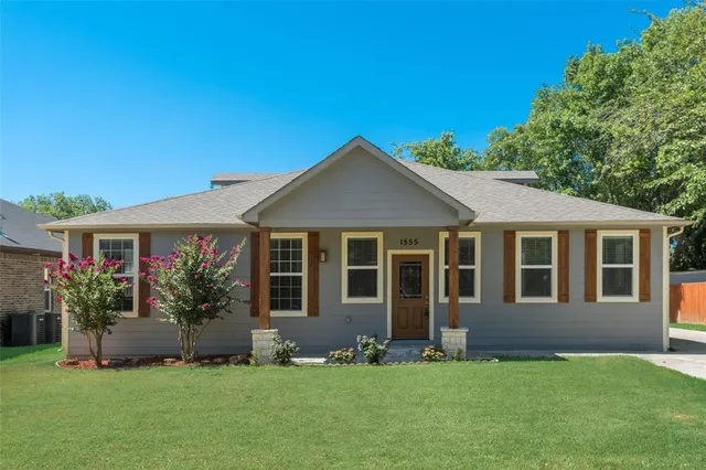a front view of a house with a yard