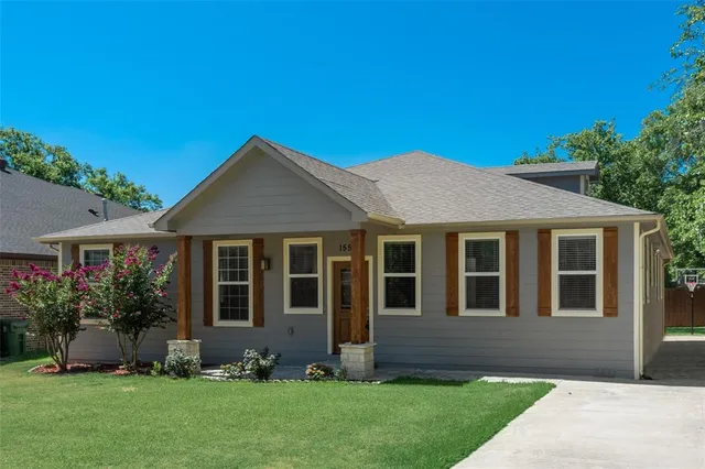 a front view of a house with a garden and plants