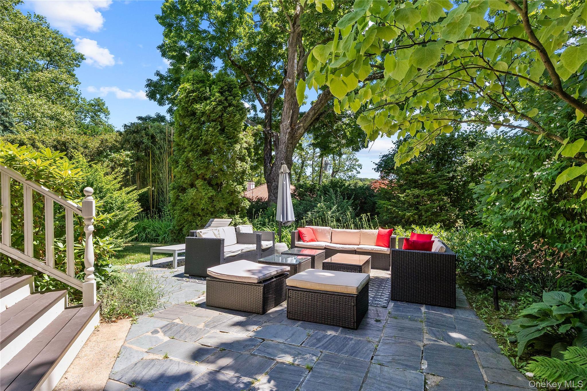 19 Howe Place Bronxville, NY 10708 - Photo 29 of 37 Expansive outdoor patio featuring flagstone paving and mature perimeter landscaping