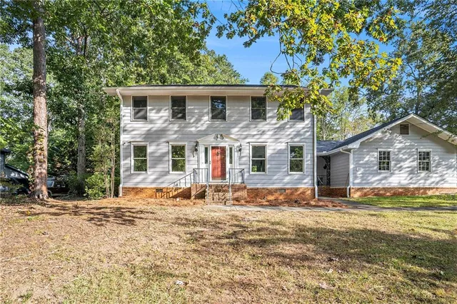 a front view of a house with a yard