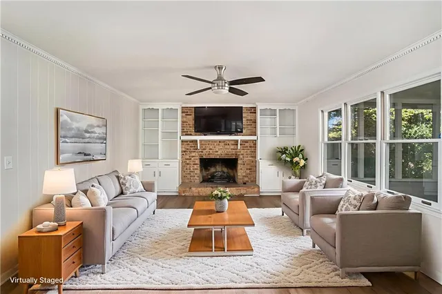 a living room with furniture and a fireplace