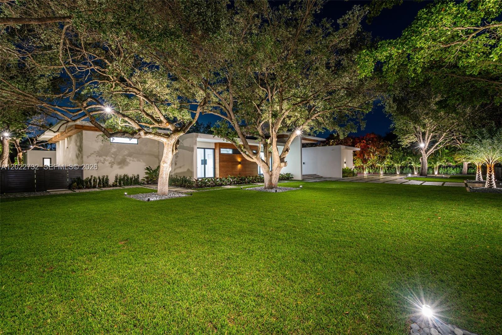 7825 Southwest 128th Street Pinecrest, FL 33156 - Photo 75 of 88 a view of a white house with a big yard and large trees