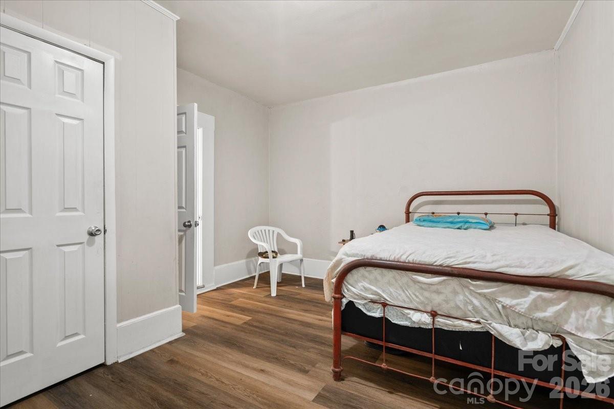 501 Church Street Cheraw, SC 29520 - Photo 11 of 48 a bedroom with a bed and wooden floor