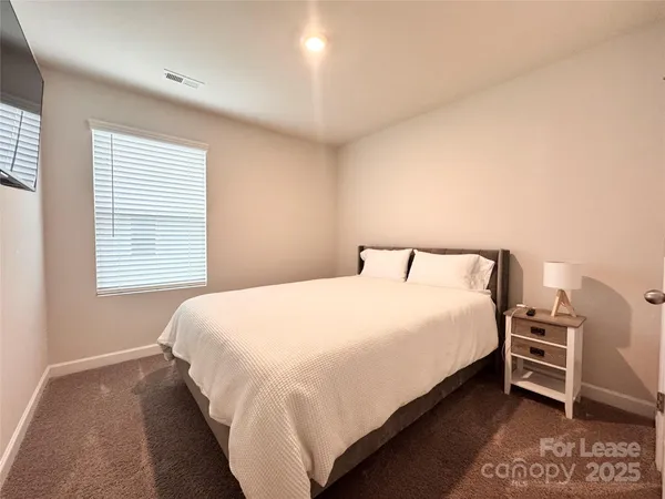 a bedroom with a bed and dresser