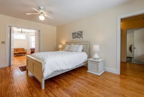 a bedroom with a bed and a chandelier