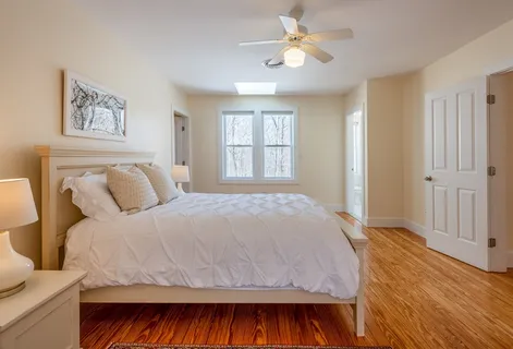 a bedroom with a large bed and a window