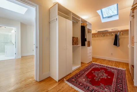 a view of a hallway with wooden floor and door