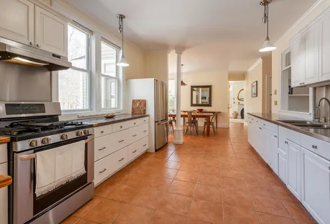 a large kitchen with stainless steel appliances granite countertop a stove and a sink