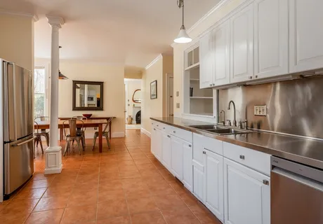 a large kitchen with kitchen island granite countertop a large counter top and stainless steel appliances