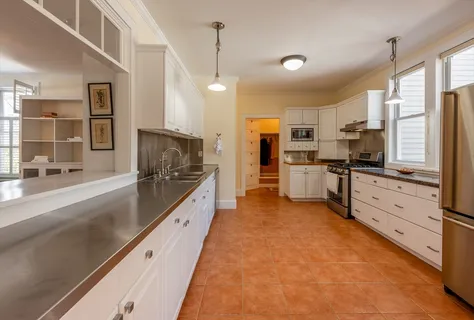 a large kitchen with stainless steel appliances kitchen island granite countertop a large counter top stainless steel appliances and cabinets