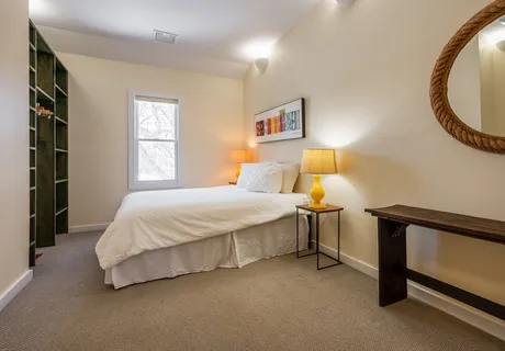 a spacious bedroom with a bed and a window