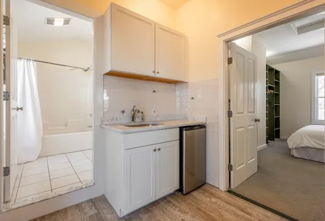 a bathroom with a sink a mirror and a shower