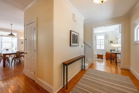 a view of a livingroom with furniture and hardwood floor