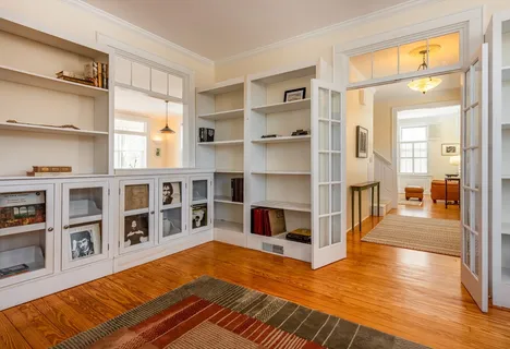 a living room with furniture and a book shelf
