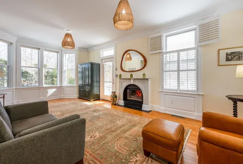 a living room with furniture a window and a fireplace