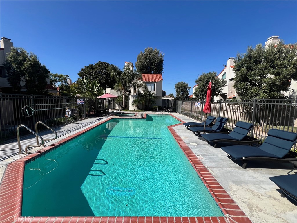 16083 Crete Lane Huntington Beach, CA 92649 - Photo 19 of 22 a view of a swimming pool with a patio and a yard