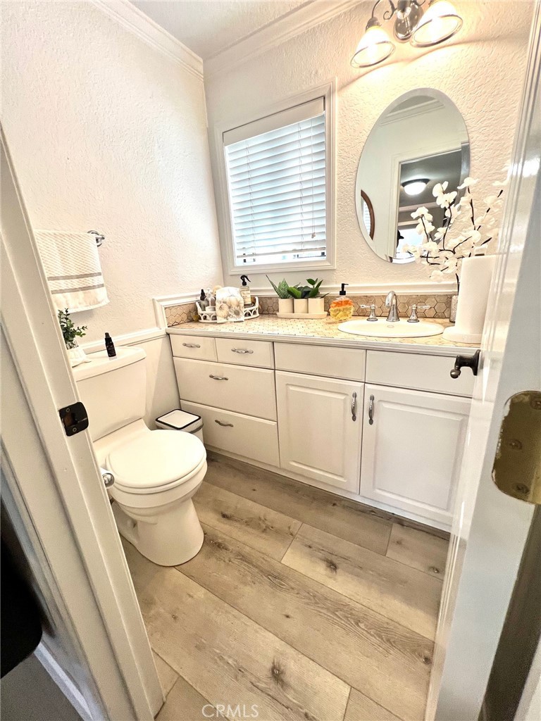 16083 Crete Lane Huntington Beach, CA 92649 - Photo 6 of 22 a bathroom with a sink a toilet and a mirror