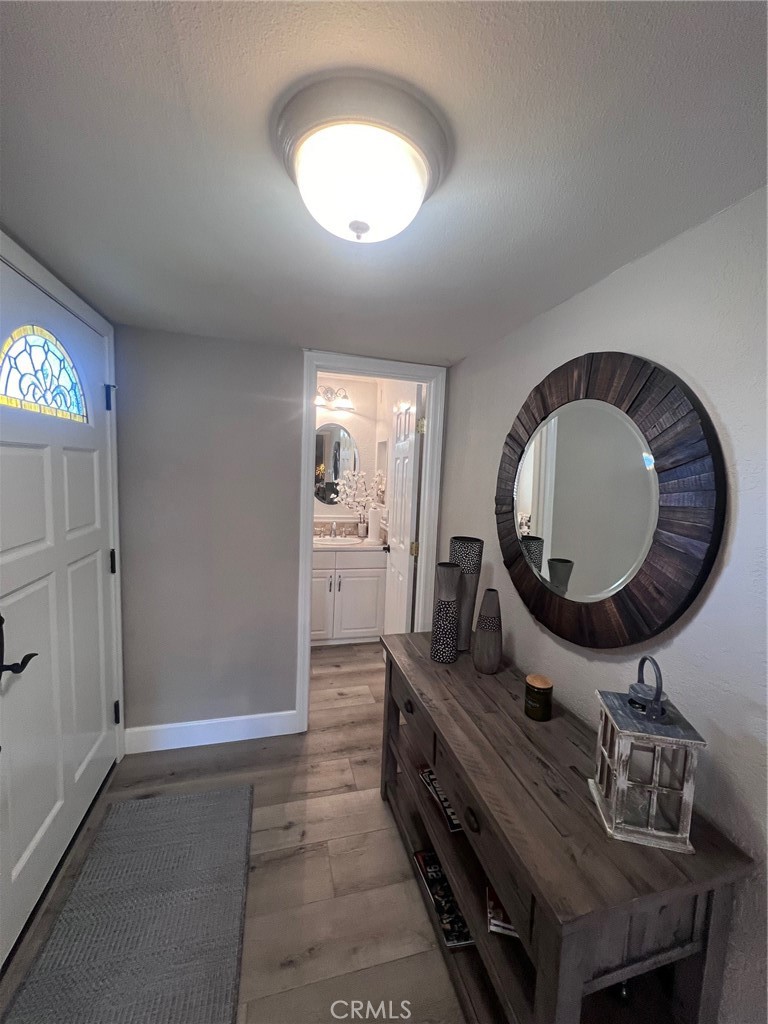 16083 Crete Lane Huntington Beach, CA 92649 - Photo 7 of 22 a living room with furniture a mirror and a wooden floor
