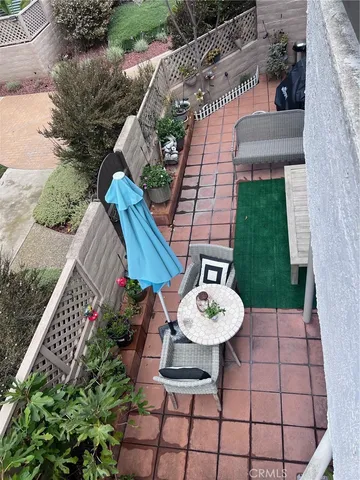 a view of a chairs and table in backyard