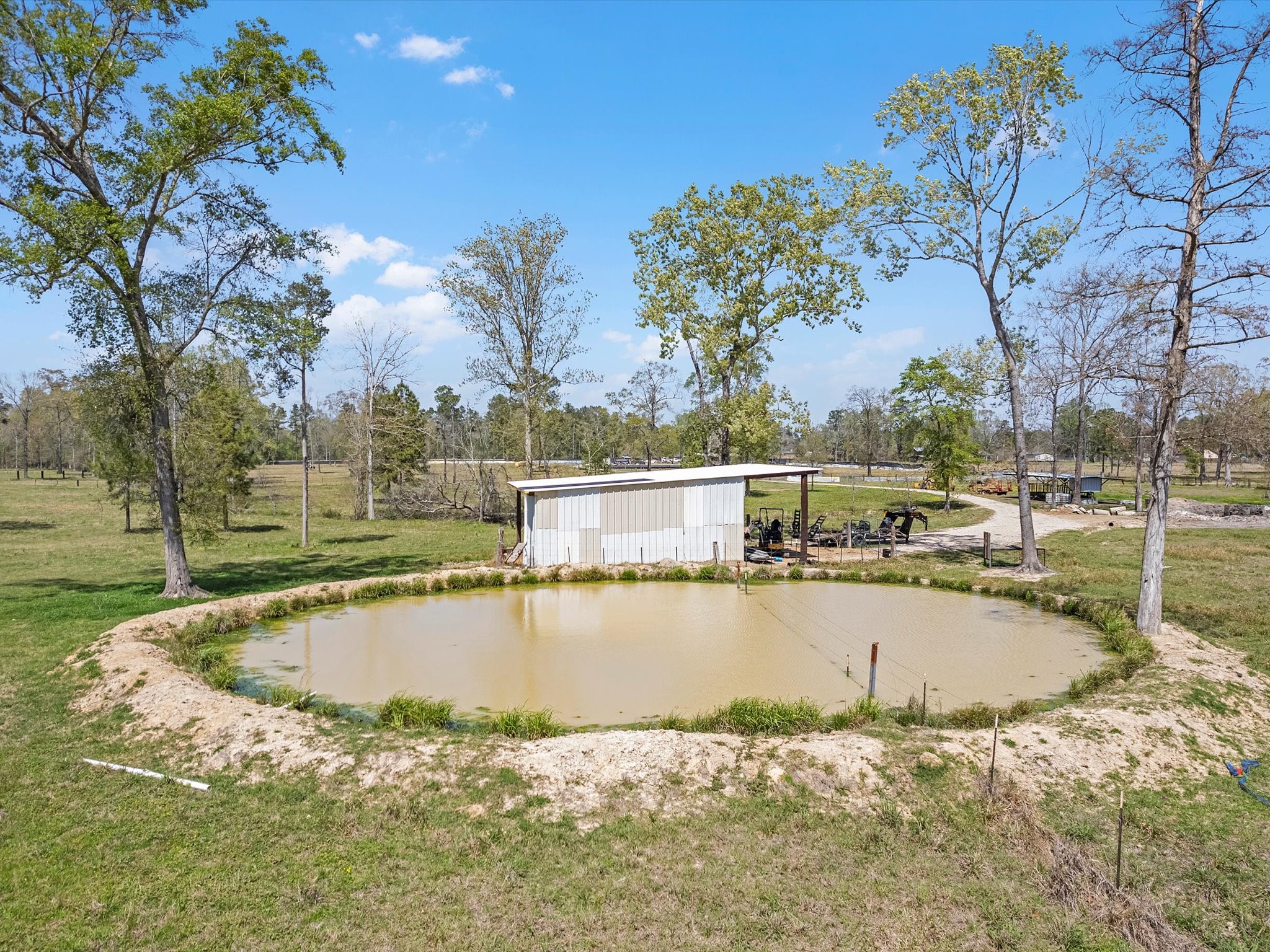 1164 County Road 332 Cleveland, TX 77327 - Photo 16 of 24 a view of a swimming pool with an outdoor space and seating area
