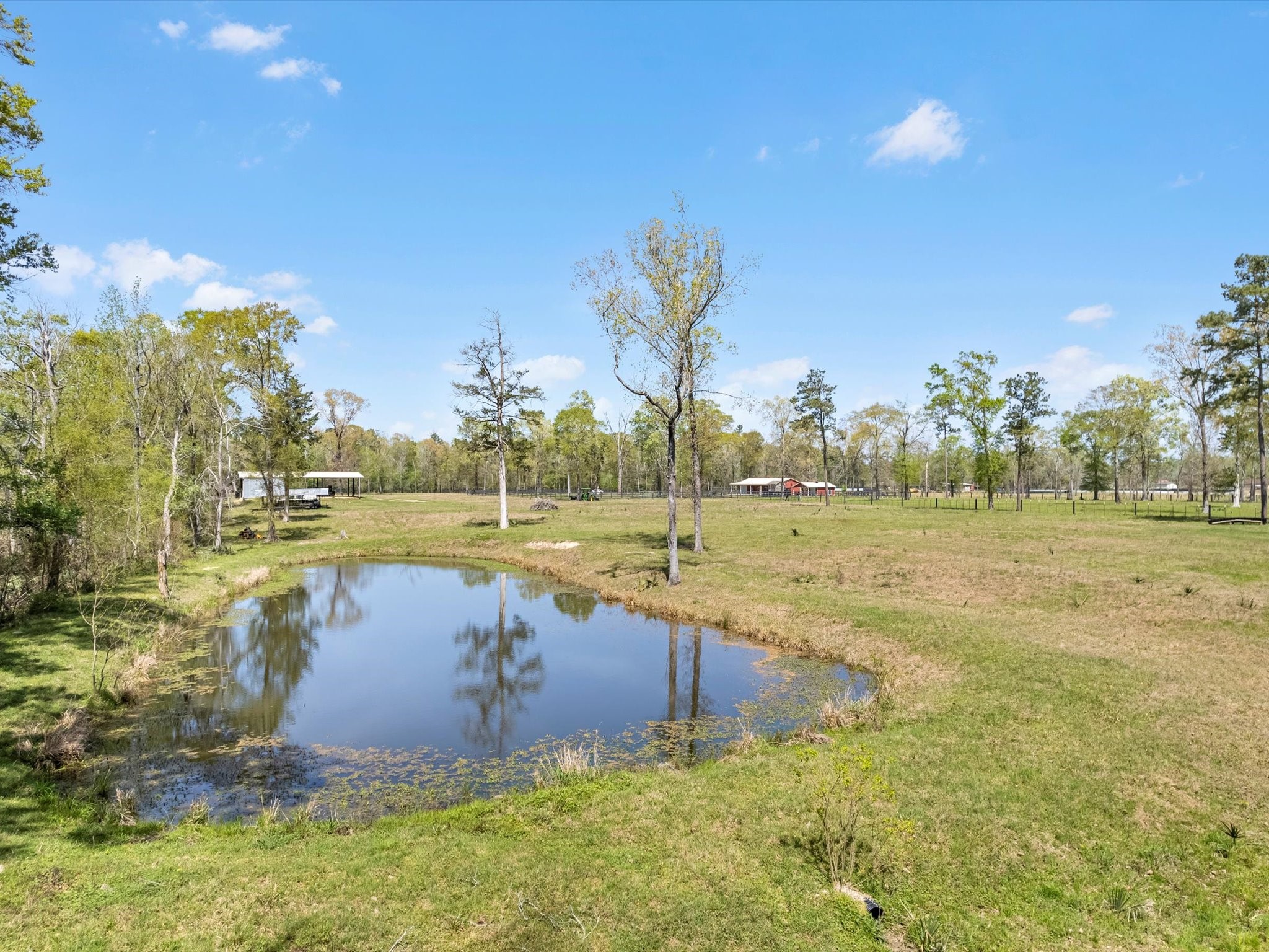 1164 County Road 332 Cleveland, TX 77327 - Photo 21 of 24 a view of a lake with houses with outdoor space