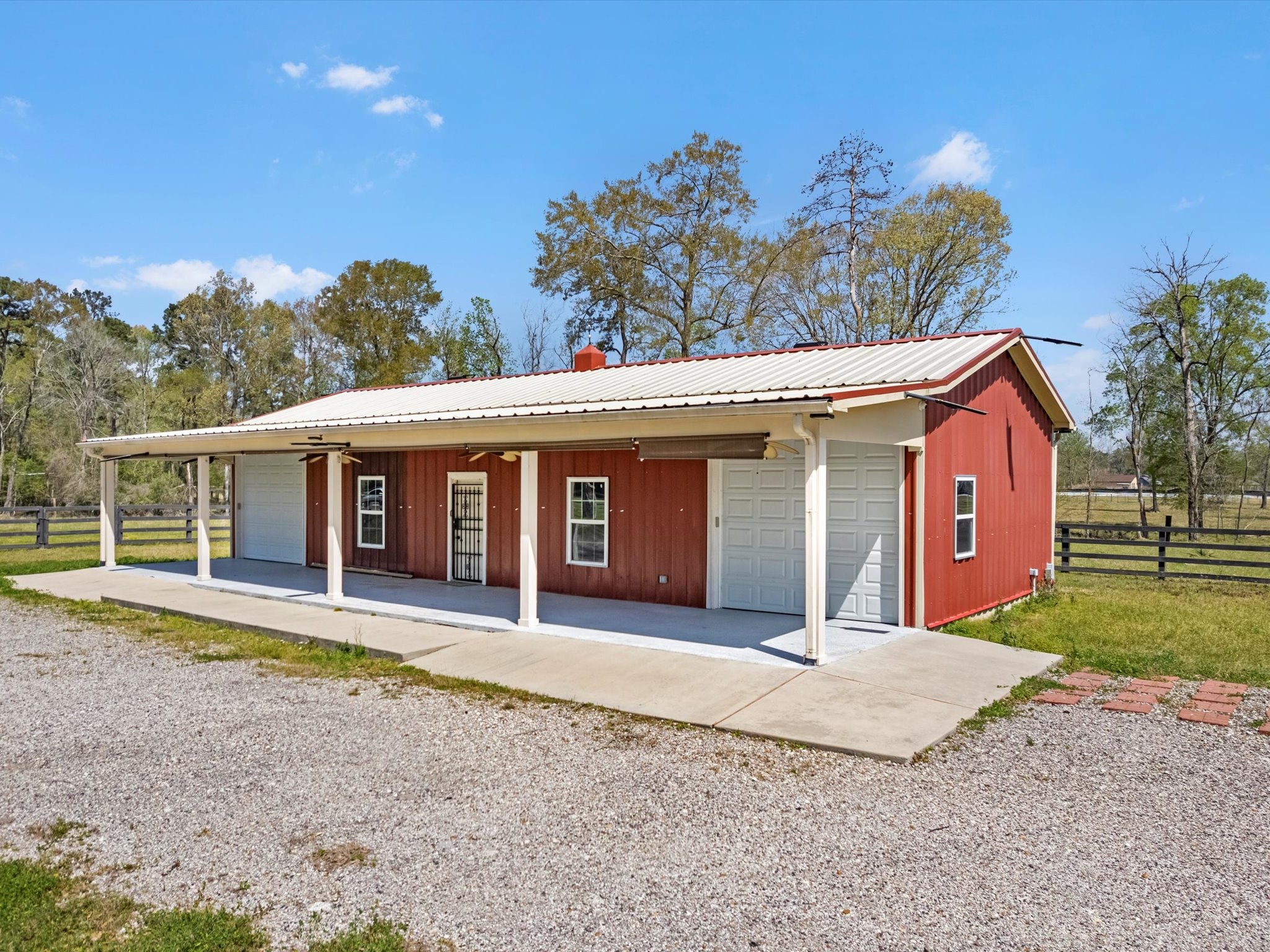 1164 County Road 332 Cleveland, TX 77327 - Photo 9 of 24 a front view of a house with a yard and garage