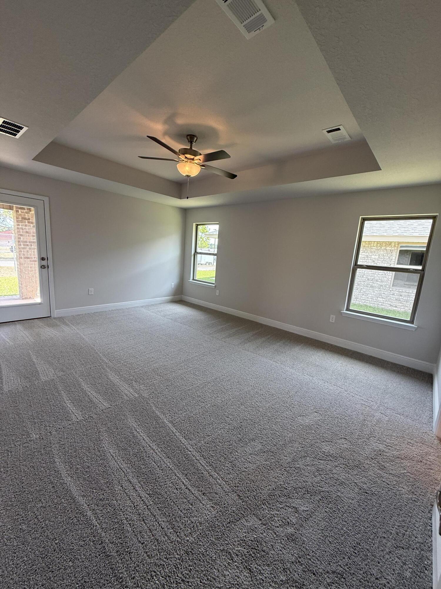 194 Ridgeway Circle Crestview, FL 32536 - Photo 12 of 25 an empty room with windows and ceiling fan