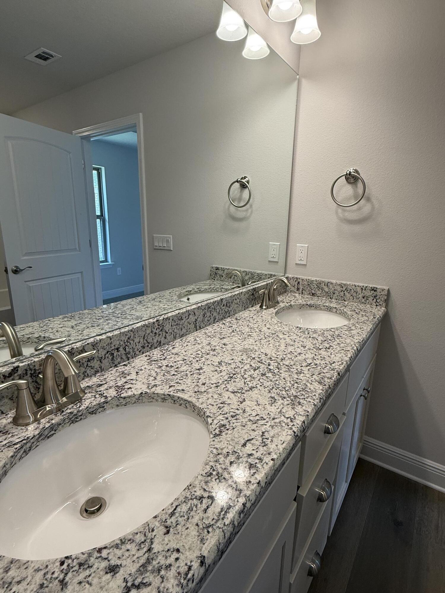 194 Ridgeway Circle Crestview, FL 32536 - Photo 17 of 25 a bathroom with a granite countertop sink and a mirror