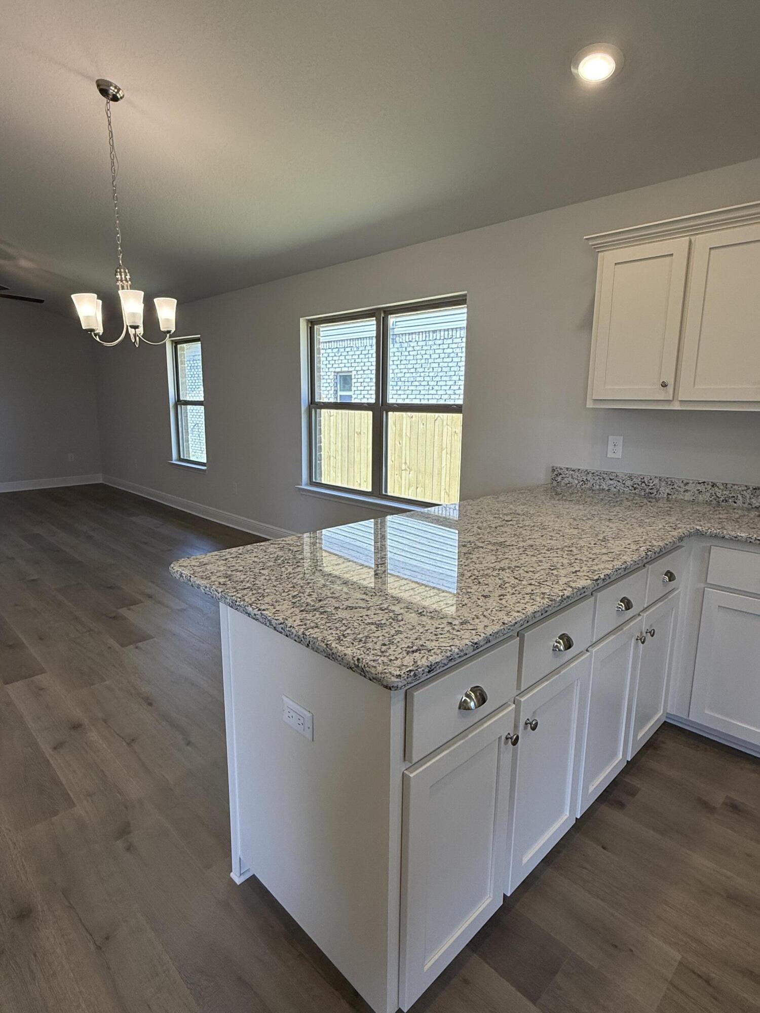 194 Ridgeway Circle Crestview, FL 32536 - Photo 19 of 25 a kitchen with granite countertop cabinets stainless steel appliances a sink and a window
