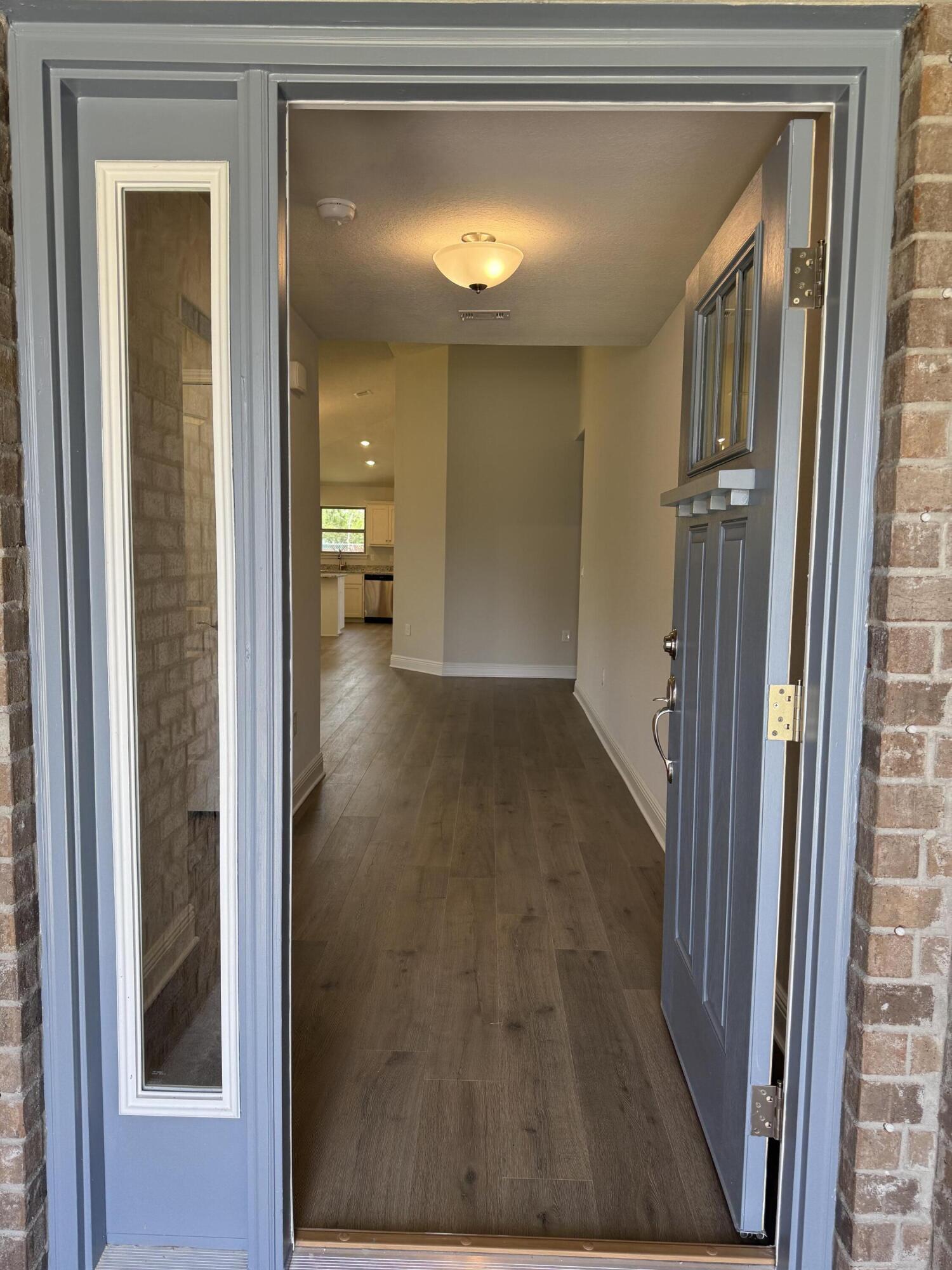194 Ridgeway Circle Crestview, FL 32536 - Photo 4 of 25 a view of a hallway with wooden floor and a bathroom