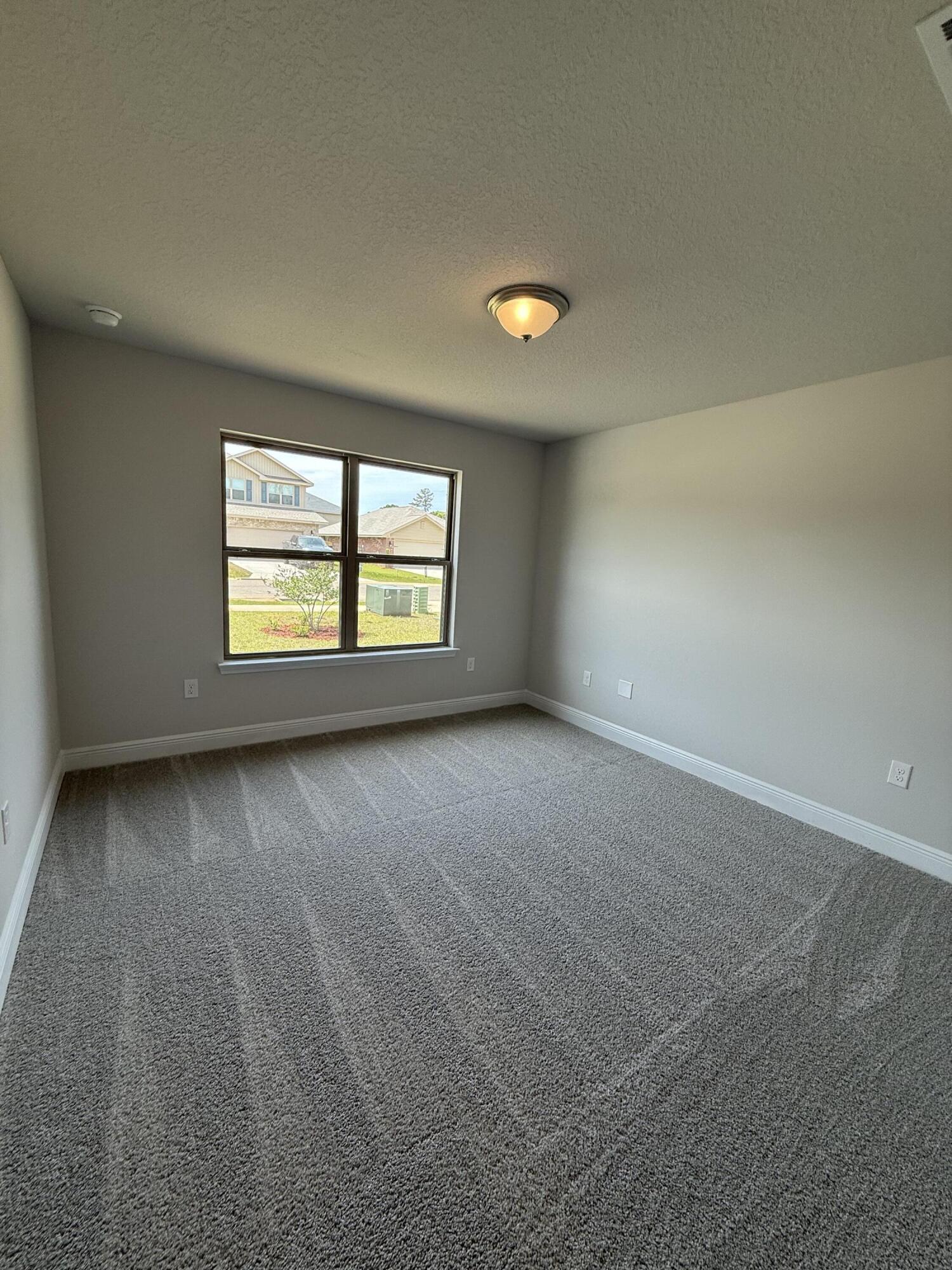 194 Ridgeway Circle Crestview, FL 32536 - Photo 7 of 25 an empty room with windows