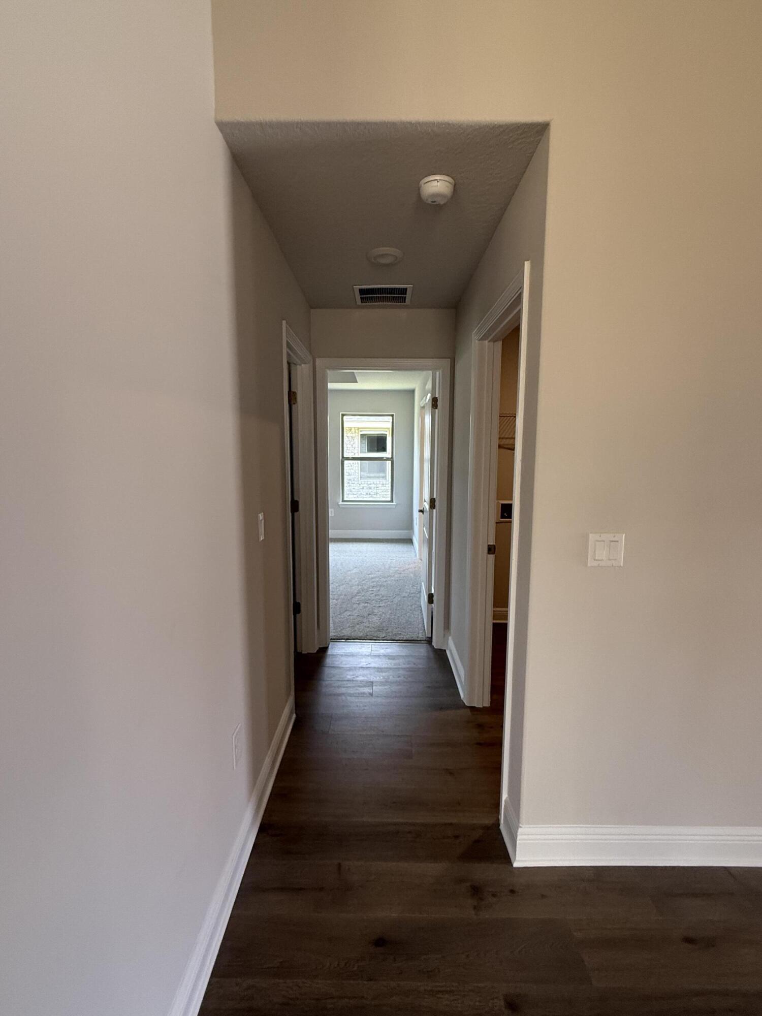 194 Ridgeway Circle Crestview, FL 32536 - Photo 9 of 25 a view of a hallway with wooden floor
