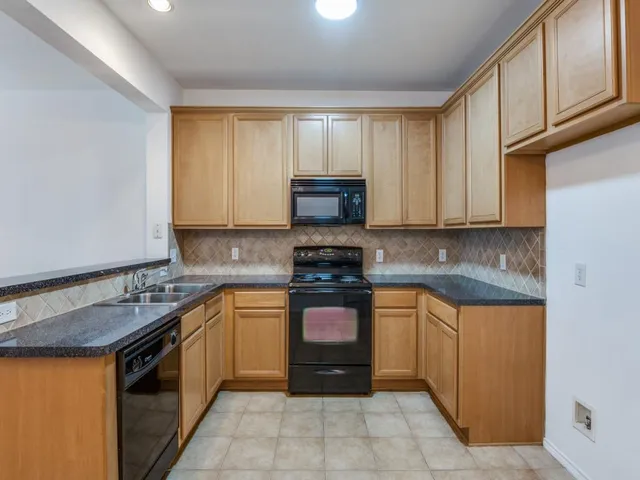 a kitchen with stainless steel appliances granite countertop a stove and a sink