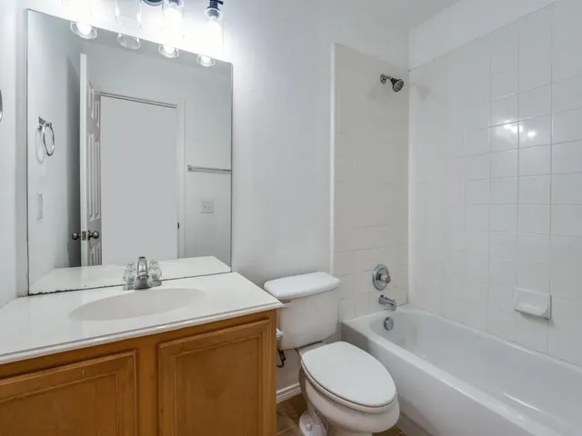 a bathroom with a sink toilet vanity and shower