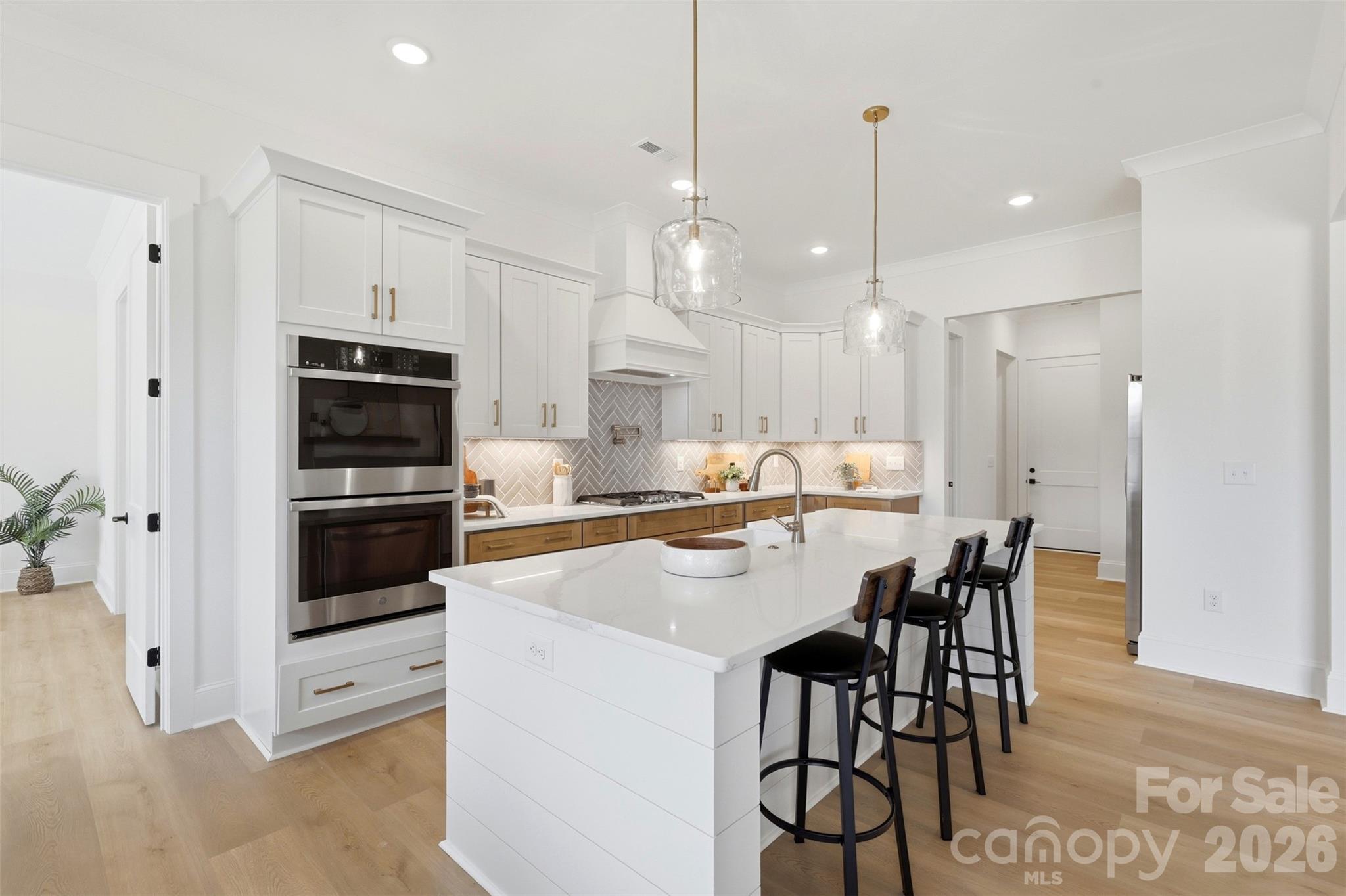 4734 Polk Ford Road Stanfield, NC 28163 - Photo 14 of 48 a kitchen with stainless steel appliances kitchen island granite countertop a dining table chairs and white cabinets