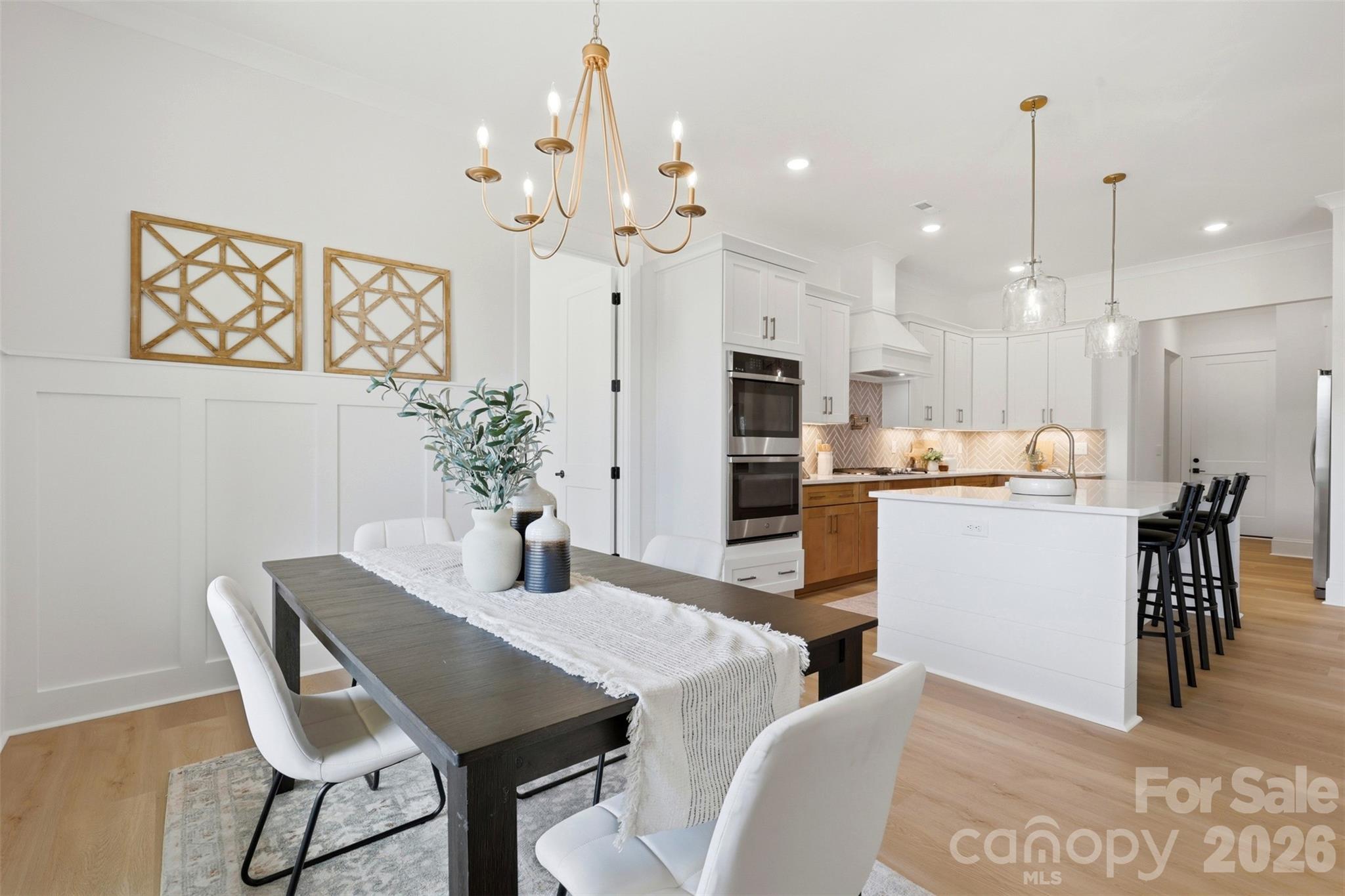 4734 Polk Ford Road Stanfield, NC 28163 - Photo 19 of 48 a kitchen with kitchen island a dining table chairs stainless steel appliances and cabinets