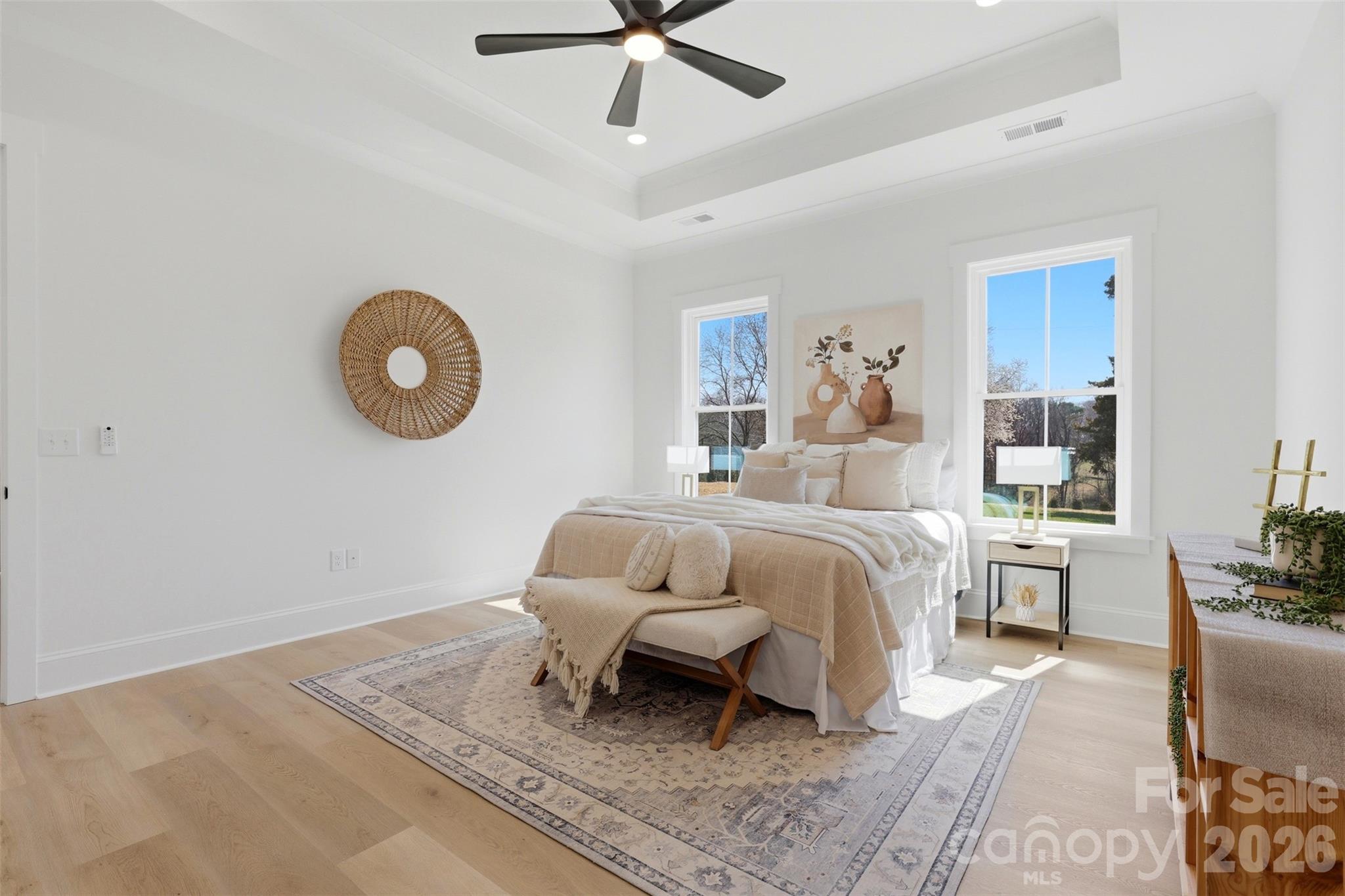 4734 Polk Ford Road Stanfield, NC 28163 - Photo 24 of 48 a spacious bedroom with a bed a couch and a chandelier