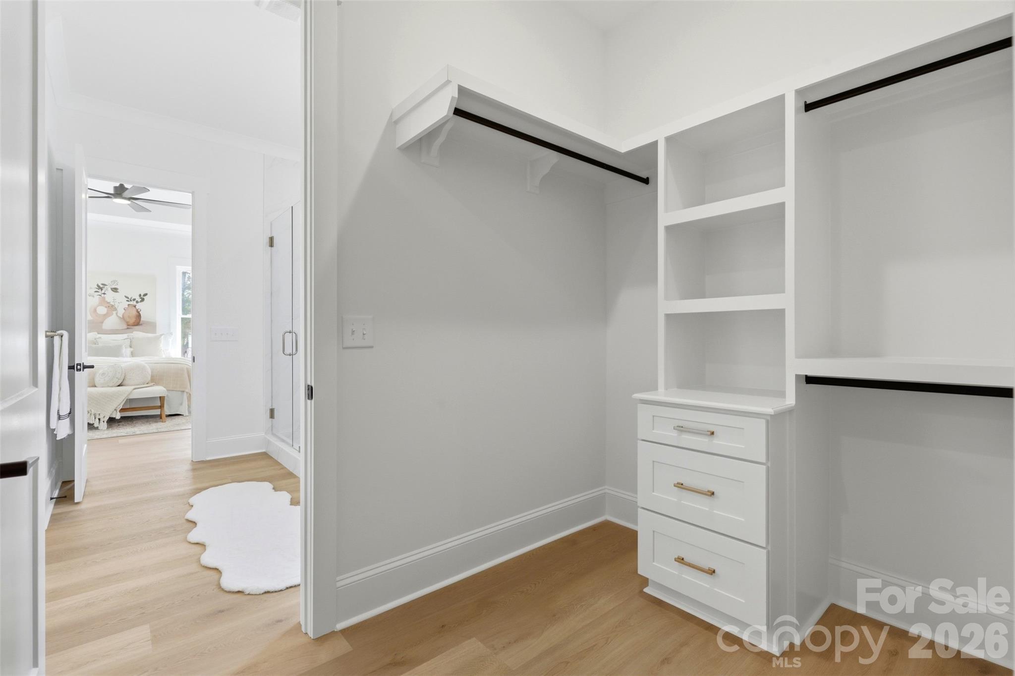 4734 Polk Ford Road Stanfield, NC 28163 - Photo 29 of 48 a hallway with white cabinets and wooden floor