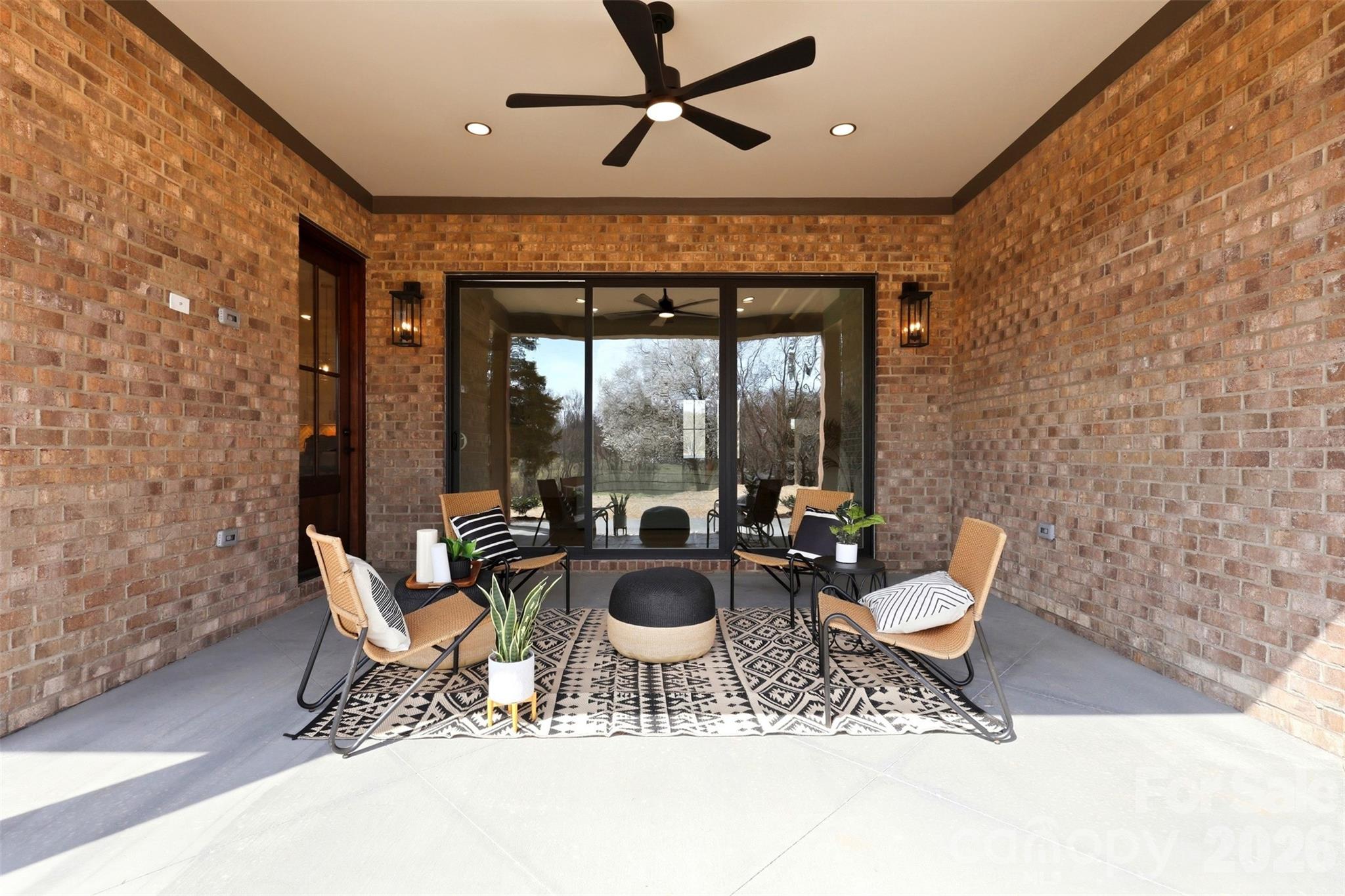 4734 Polk Ford Road Stanfield, NC 28163 - Photo 42 of 48 a living room with a patio furniture and a floor to ceiling window