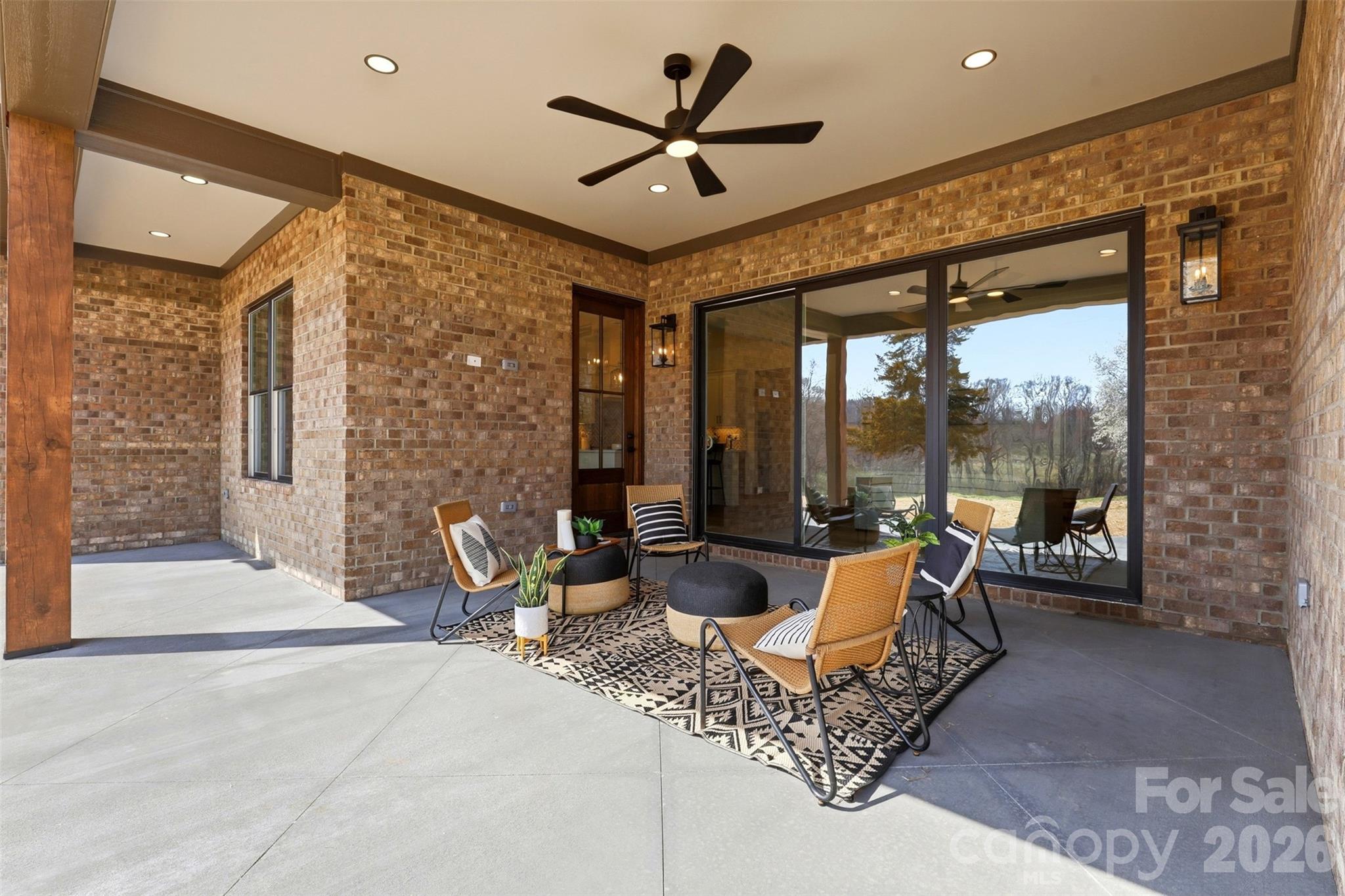 4734 Polk Ford Road Stanfield, NC 28163 - Photo 43 of 48 a living room with patio furniture and a floor to ceiling window