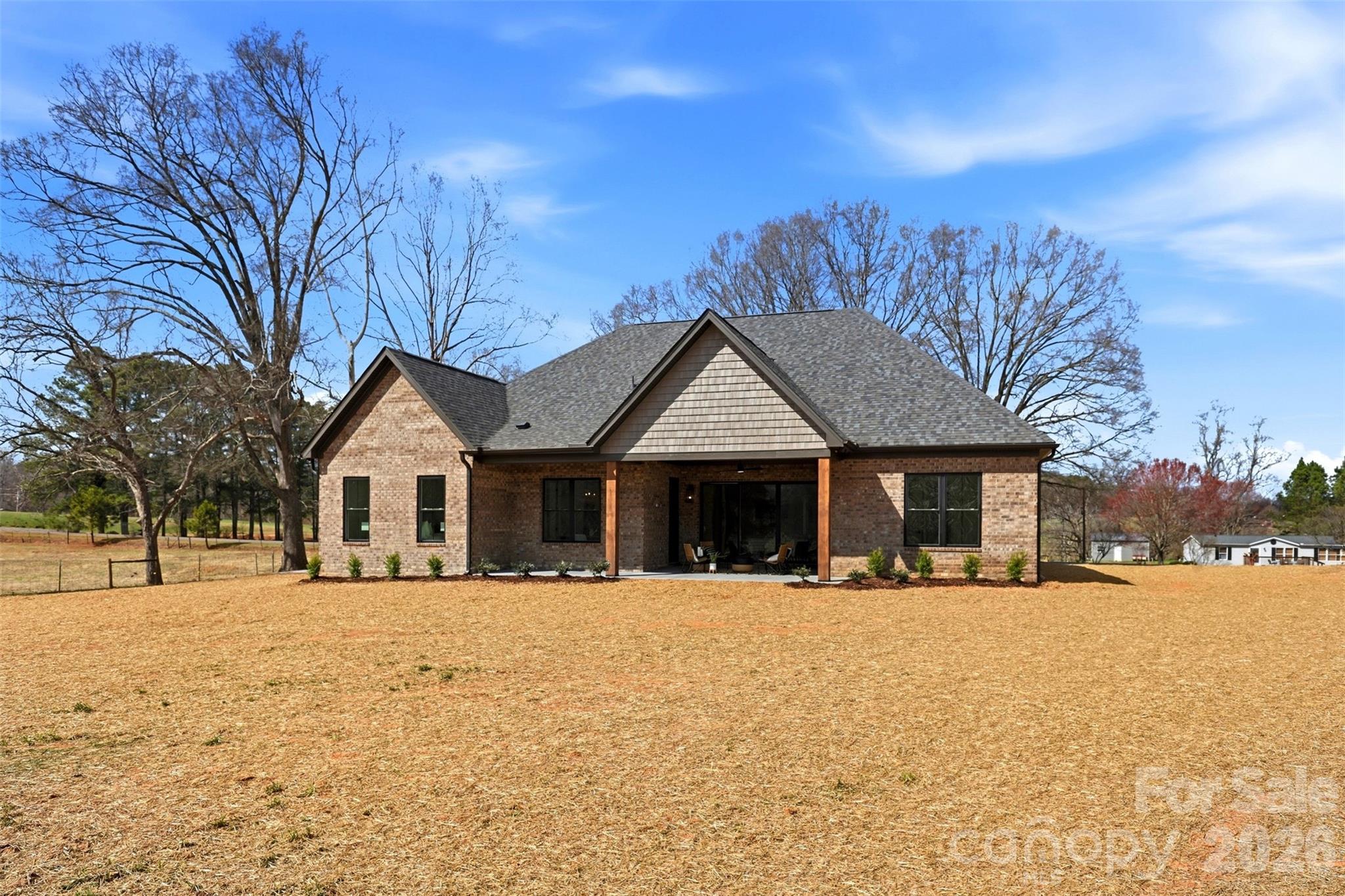 4734 Polk Ford Road Stanfield, NC 28163 - Photo 46 of 48 a front view of a house with a yard covered with snow